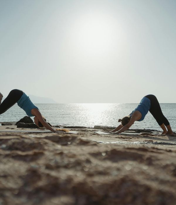 Person stretching outdoors, feeling energized by the morning sun.